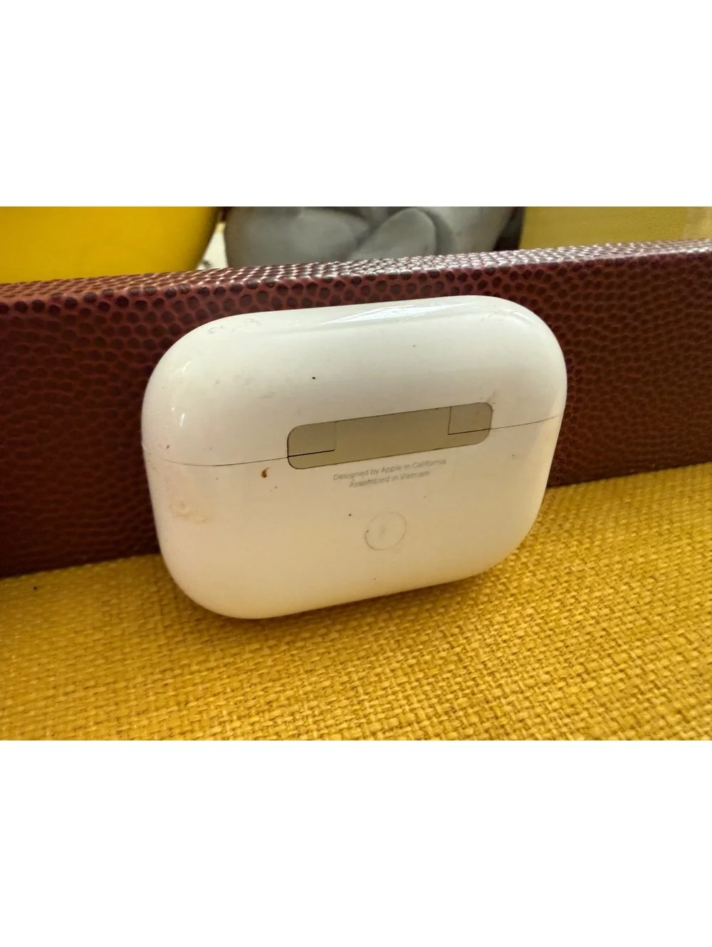 AirPods charger and half of a Cheetos case